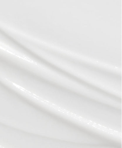 A smear of Dr. Groot Professional Bonding System Bond Fortifying #3 Conditioner on a white surface. Rich, creamy conditioner infused with keratin and biotin, designed to deeply nourish and repair hair strands.